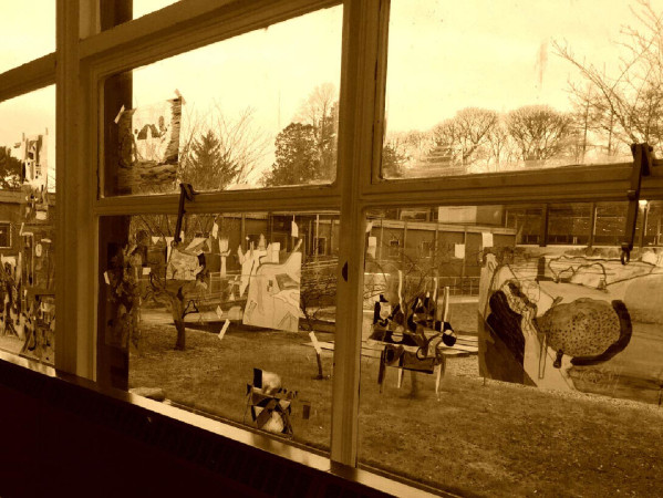 Sepia toned image of a window with artwork stuck to it Sepia toned image of a window with artwork stuck to it