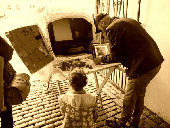 Sepia toned image of people making models Sepia toned image of people making models