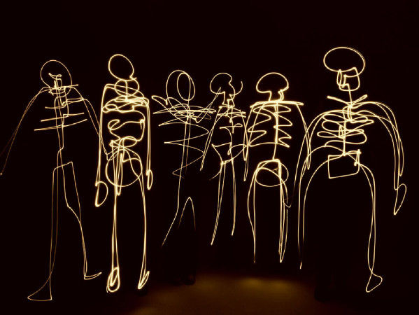 Sepia toned image of skeletons made from light streams Sepia toned image of skeletons made from light streams