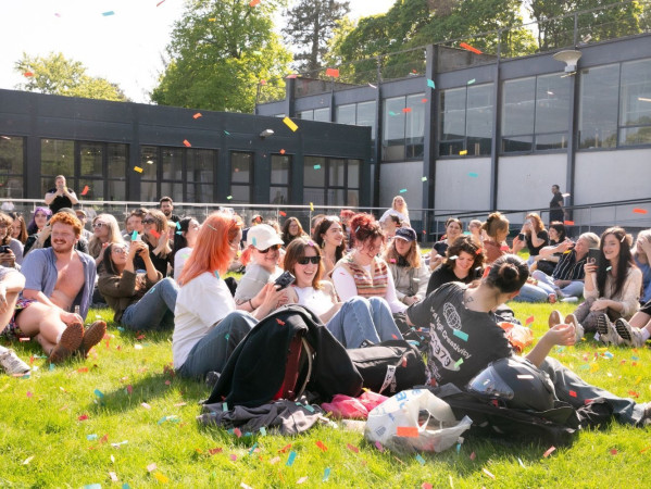 Image shows Gray's School of Art students celebrating with confetti after handing in their degree show projects