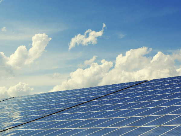 A solar panel board with a blue sky
