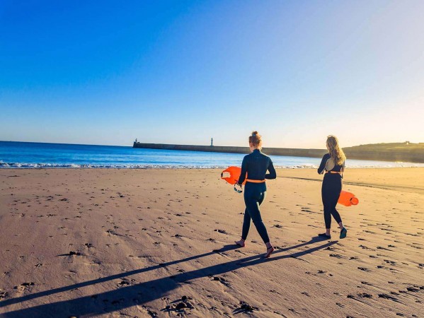 Two surfers walking on the beach