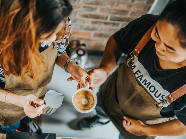 two people making a coffee two people making a coffee